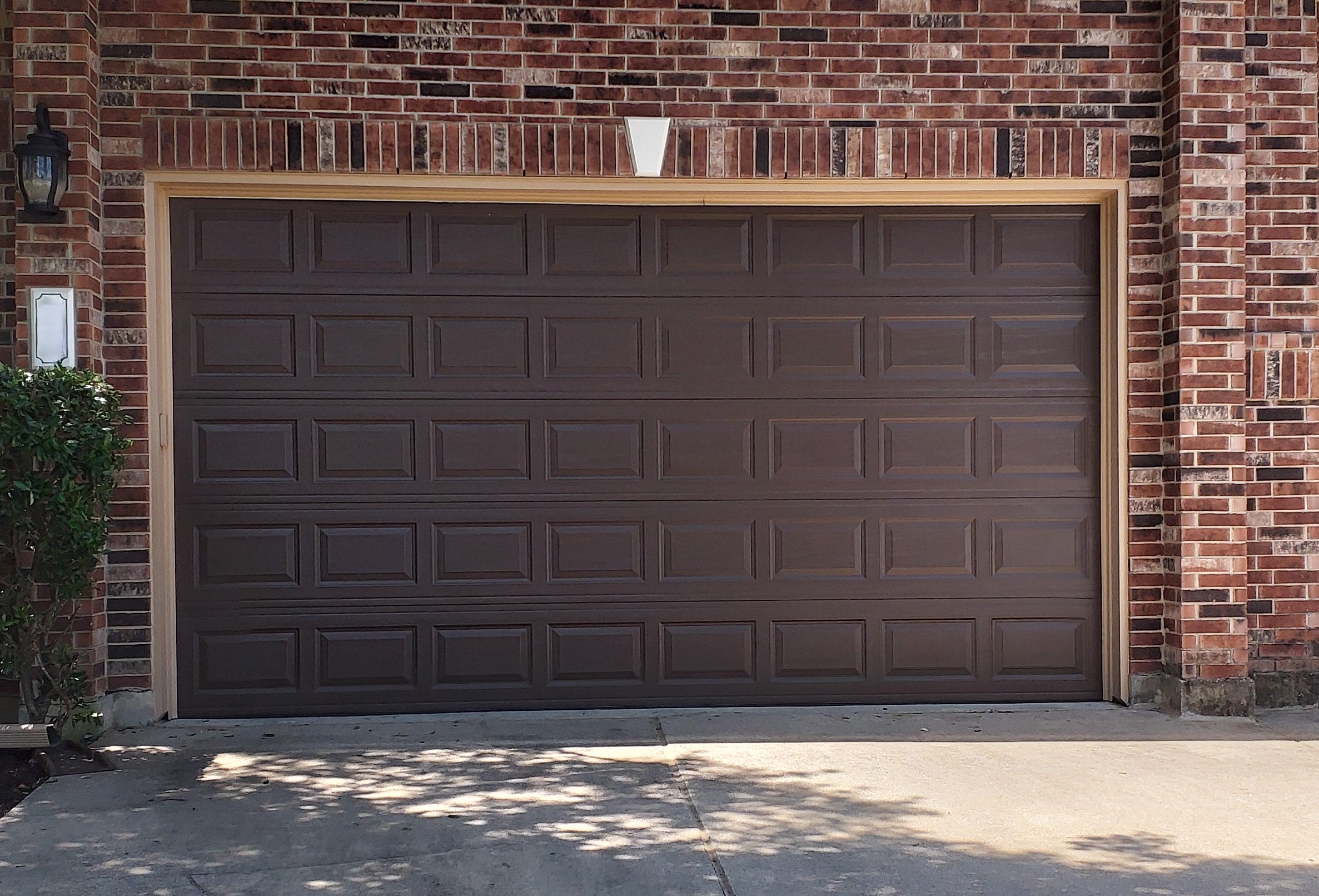 Newly installed 16 by 8 brown insulated garage door
