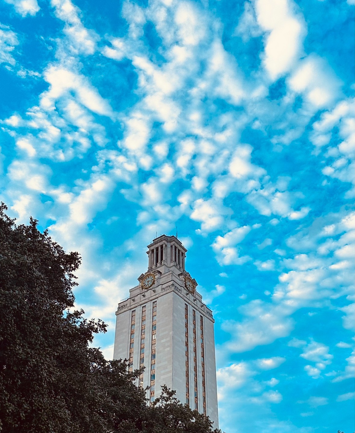 The University of Texas Tower against a cloud-dappled sky