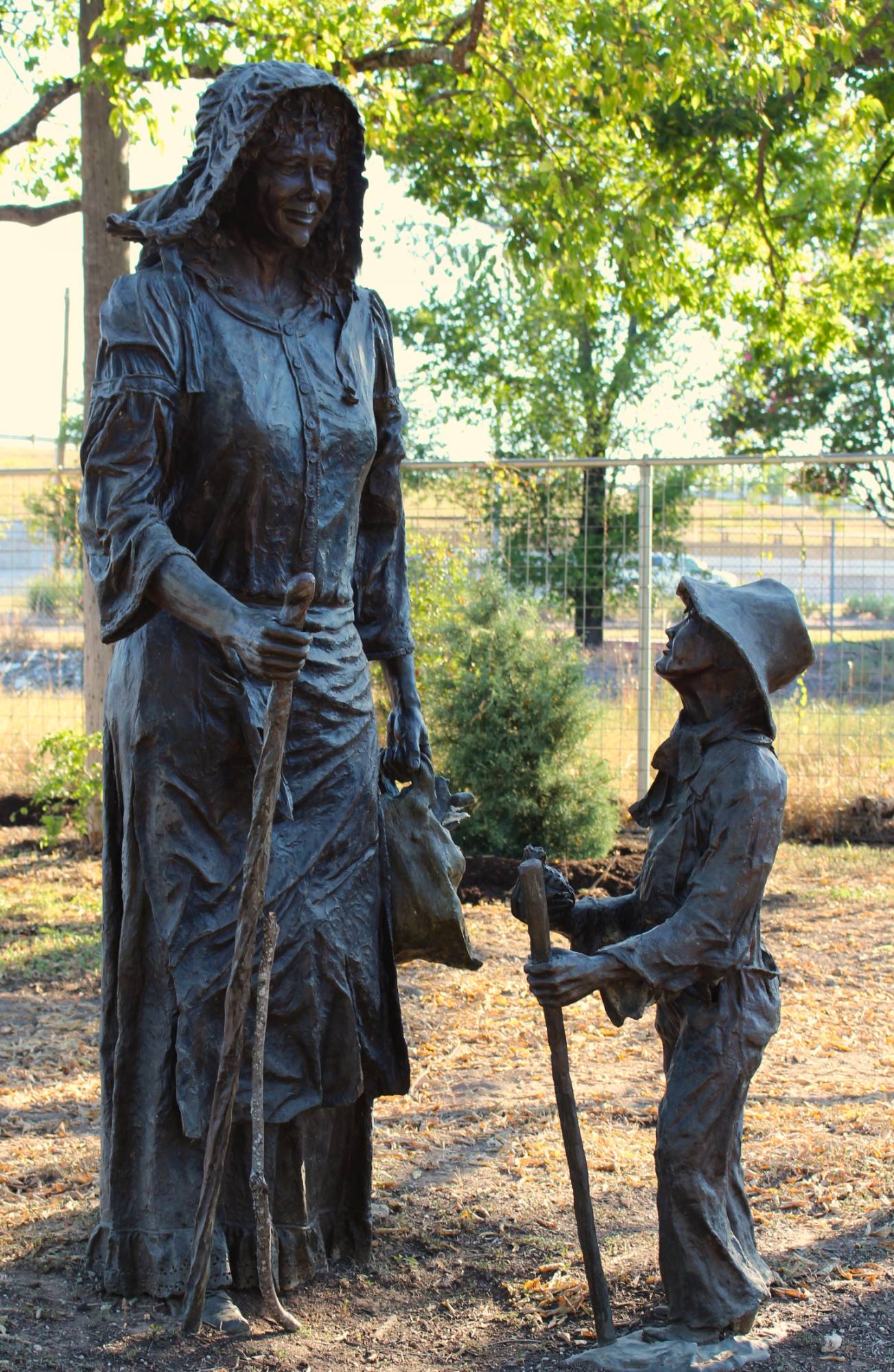 Pioneer woman and child bronze statues on the Chisholm Trail in Round Rock