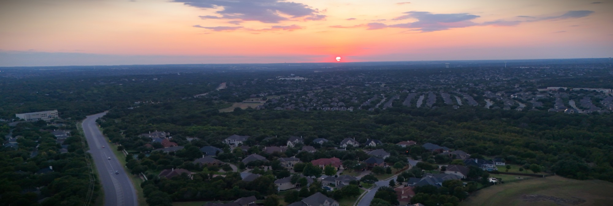 Sunset drone view over Round Rock, Texas neighborhoods